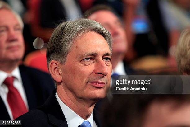 British Chancellor of the Exchequer Philip Hammond reacts as British Prime Minister Theresa May starts to deliver a keynote address on the final day...