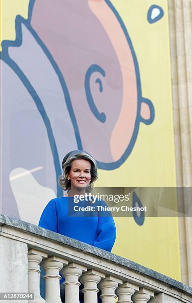 Queen Mathilde of Belgium poses for photos in front of a giant poster of comic character Tintin on October 5, 2016 in Paris, France. Queen Mathilde...