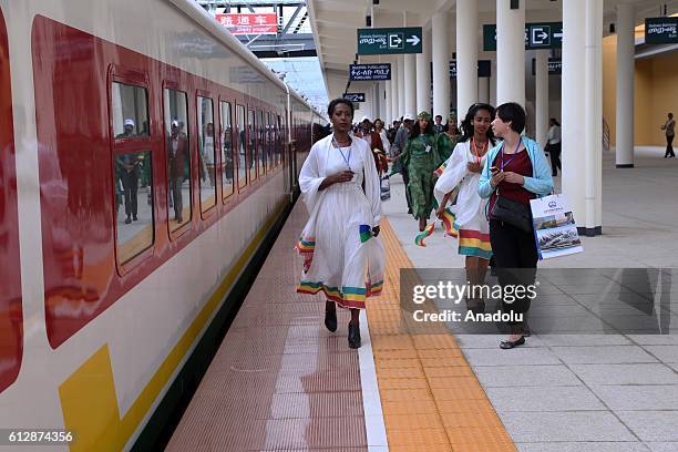 People are seen during an opening ceremony of a railroad line, which is Africa's longest and its first electrified railway line connecting Ethiopia's...