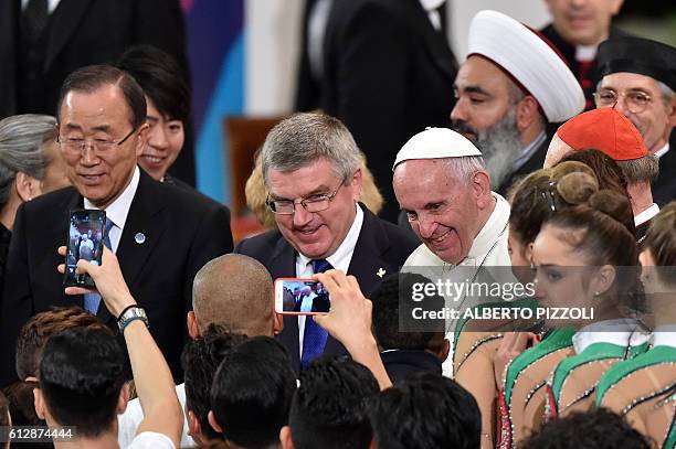 Pope Francis poses with head of the International Olympic Committee Thomas Bach and UN secretary general Ban Ki Moon during the opening ceremony of a...