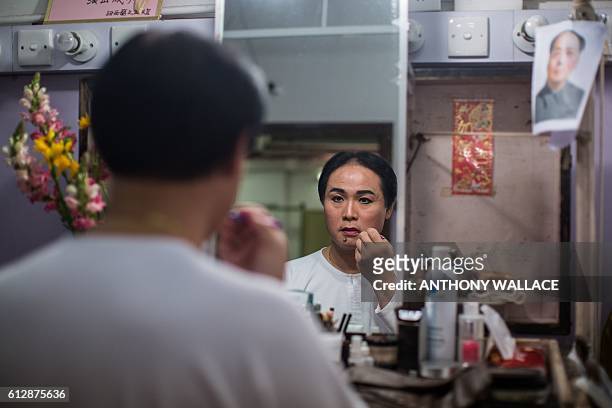 In this picture taken on October 4 Cantonese opera artist Lung Koon-tin prepares backstage before playing late Chinese communist leader Mao Zedong in...
