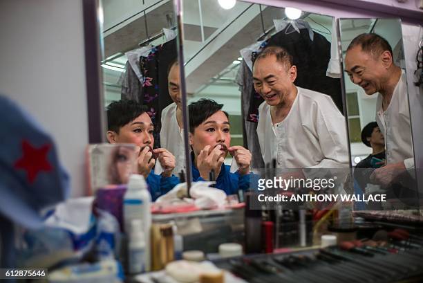 In this picture taken on October 4 Cantonese opera actors prepare backstage before performing in a show portraying late Chinese communist leader Mao...