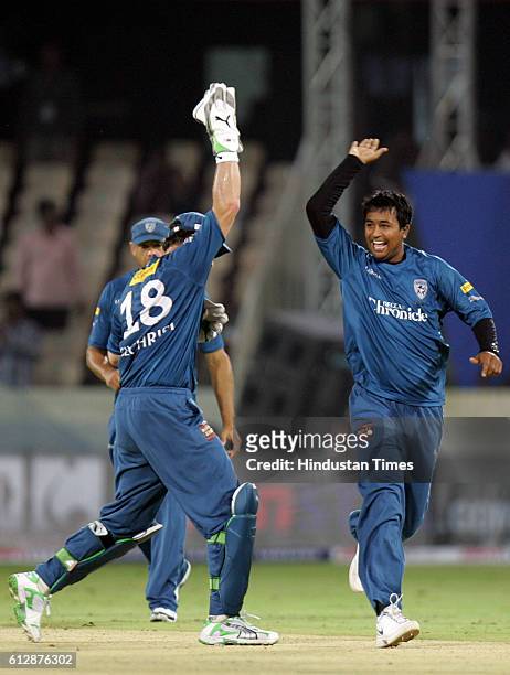 Adam Gilchrist of the Chargers celebrates with Ojha during the Airtel Champions League Twenty20 Group A match between the Deccan Chargers and...