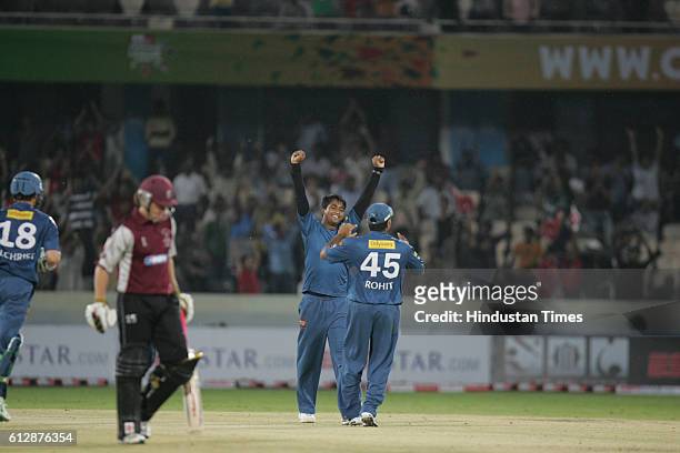 Rohit Sharma of the Chargers congratulates Pragyan Ojha wicket of C Kieswetter during the Airtel Champions League Twenty20 Group A match between the...