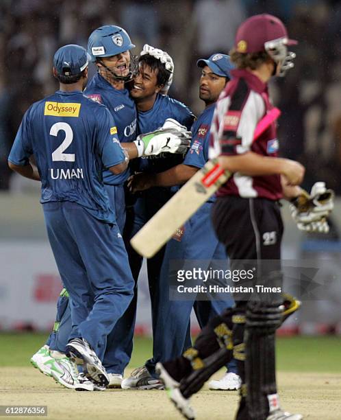 Adam Gilchrist of the Chargers celebrates with Ojha during the Airtel Champions League Twenty20 Group A match between the Deccan Chargers and...