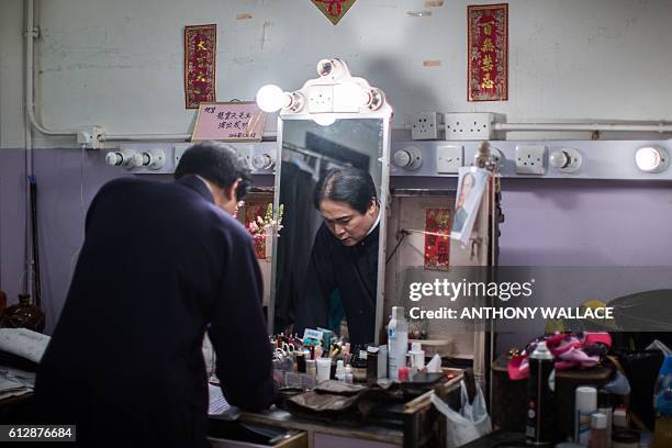 In this picture taken on October 4 Cantonese opera artist Lung Koon-tin prepares backstage before playing late Chinese communist leader Mao Zedong in...