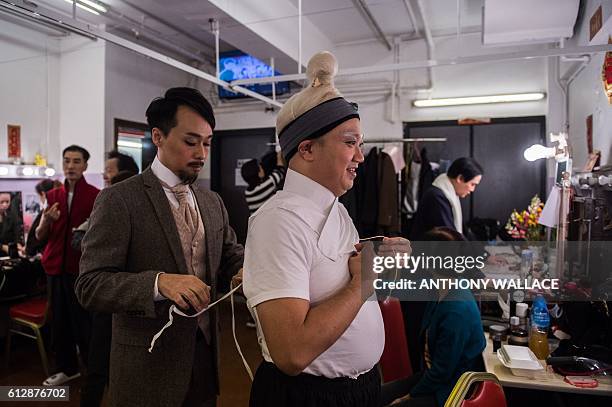 In this picture taken on October 4 Cantonese opera actors prepare backstage before performing in a show portraying late Chinese communist leader Mao...