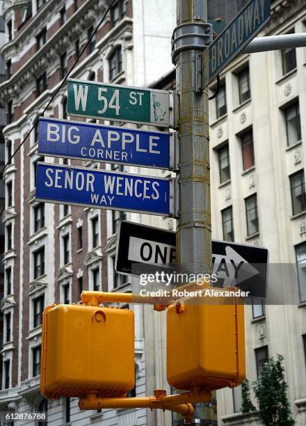 September 6, 2016: Street signs at the corner of Broadway and 54th Street in New York City identify the streets' official and honorary names. Senor...