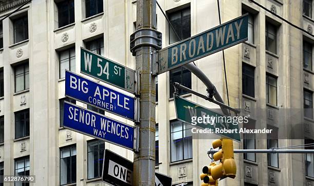 September 6, 2016: Street signs at the corner of Broadway and 54th Street in New York City identify the streets' official and honorary names. Senor...