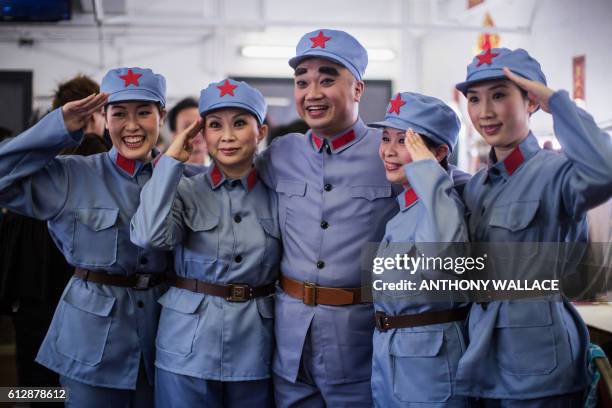 In this picture taken on October 4 a Cantonese opera actors salute backstage before performing in a show portraying late Chinese communist leader Mao...