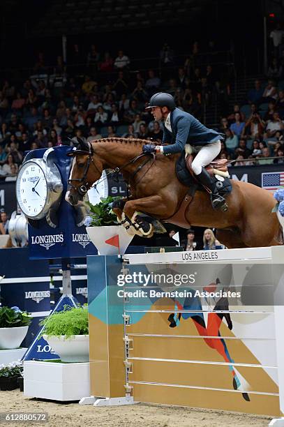 Simon Delestre of France rides Chesall Zimequest in the Longines Grand Prix during the Longines Masters of Los Angeles 2016 at Long Beach Convention...