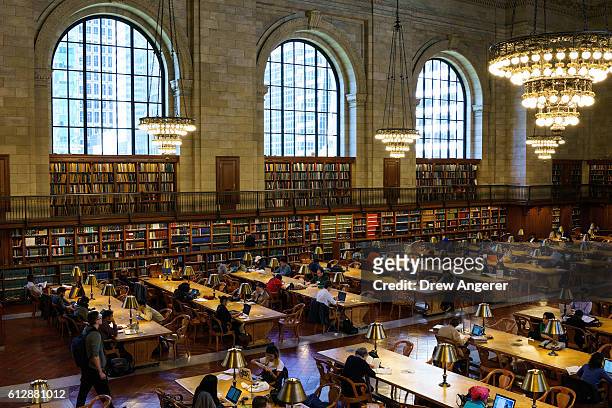 People work at desks in the Rose Main Reading Room at the New York Public Library, October 5, 2016 in New York City. The Rose Main Reading Room has...