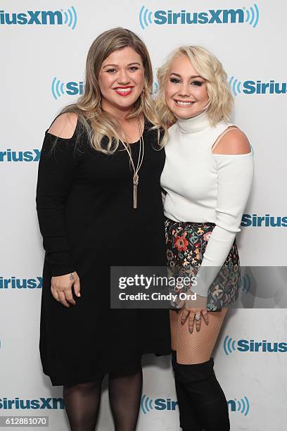 Singer Kelly Clarkson poses with singer RaeLynn at SiriusXM Studios on October 5, 2016 in New York City.