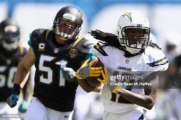 Travis Benjamin of the San Diego Chargers eludes Paul Posluszny of the Jacksonville Jaguars on a pass play during a game at Qualcomm Stadium on...