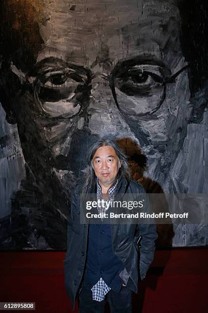 Artist Yan Pei-Ming poses in front of his work during the Coluche Exhibition Opening. This exhibition is organized for the 30 years of the...