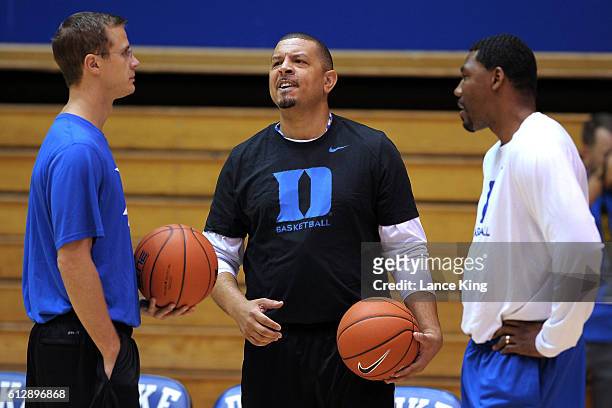 Assistant coach Jon Scheyer, associate head coach Jeff Capel and assistant coach Nate James of the Duke Blue Devils look on during a practice session...