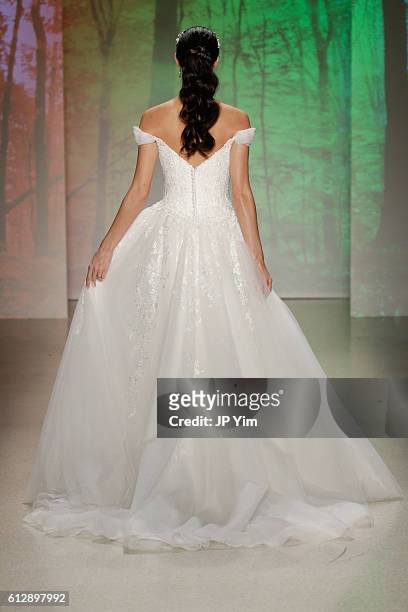 Model walks the runway at the Alfred Angelo Spring 2017 Bridal Show with Disney Weddings at EZ Studios on October 5, 2016 in New York City.