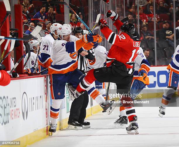 Steve Bernier of the New York Islanders and Ben Lovejoy of the New Jersey Devils colide during the third period at the Prudential Center on October...