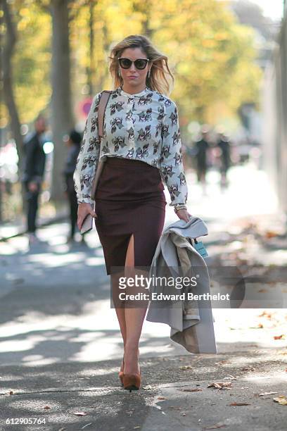 Guest is wearing a brow skirt, outside the Miu Miu show, during Paris Fashion Week Spring Summer 2017, on October 5, 2016 in Paris, France.