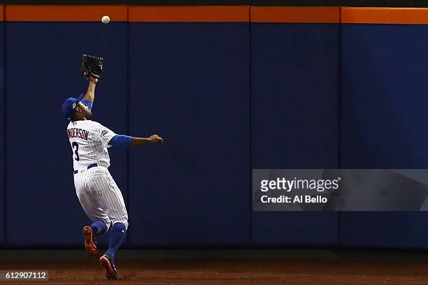 Curtis Granderson of the New York Mets catches a ball hit by Brandon Crawford of the San Francisco Giants for an out in the fifth inning during their...