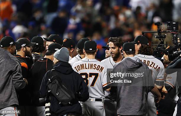 Madison Bumgarner of the San Francisco Giants celebrates with teammates after they defeated the New York Mets 3-0 to win the National League Wild...