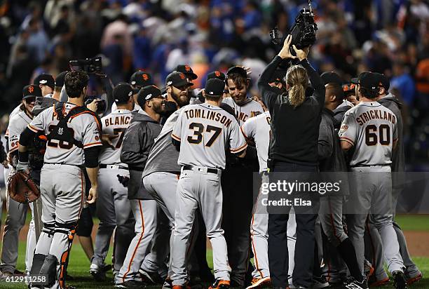 Madison Bumgarner of the San Francisco Giants celebrates with teammates after they defeated the New York Mets 3-0 to win the National League Wild...