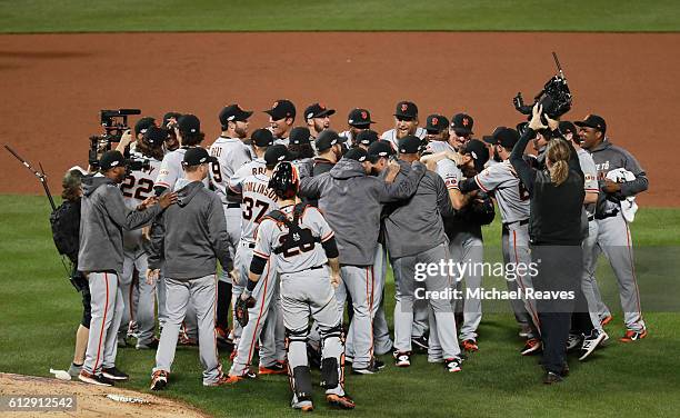 Madison Bumgarner of the San Francisco Giants celebrates with teammates after they defeated the New York Mets 3-0 to win the National League Wild...