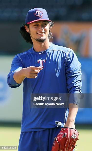 Texas Rangers pitcher Yu Darvish joins a training session on Oct. 5 ahead of the American League Division Series against the Toronto Blue Jays. The...