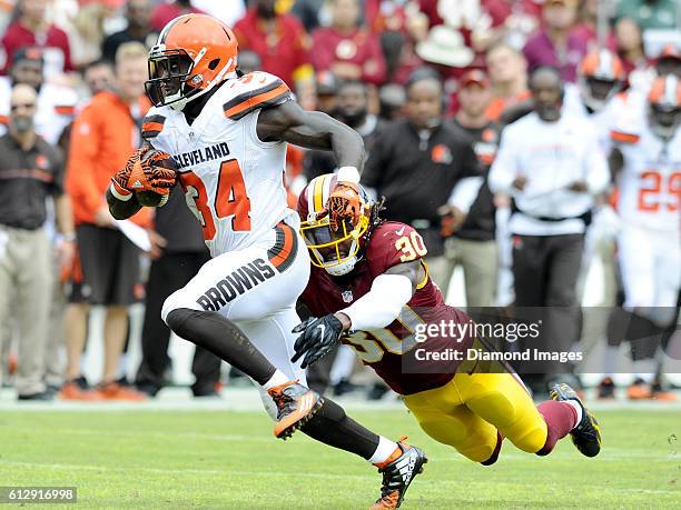 Running back Isaiah Crowell of the Cleveland Browns runs out of the tackle of safety David Bruton of the Washington Redskins during a game on October...