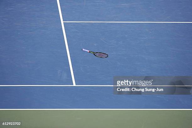 Tennis racket of Gael Monfils of France lies on the ground during his medical attention during the men's singles second round match against Gilles...