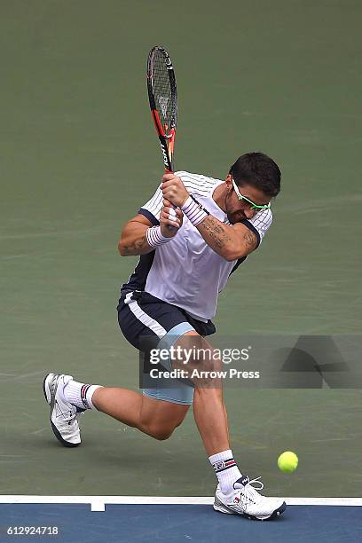 Janko Tipsarevic of Serbia plays a backhand during the men's singles second round match against Ivo Karlovic of Croatia on day four of Rakuten Open...