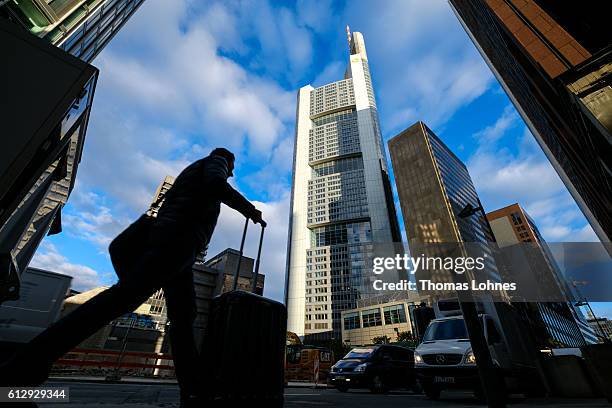 People walk past the corporate headquarters of Deutsche Bank on October 5, 2016 in Frankfurt, Germany. Banks across Europe are struggling as their...