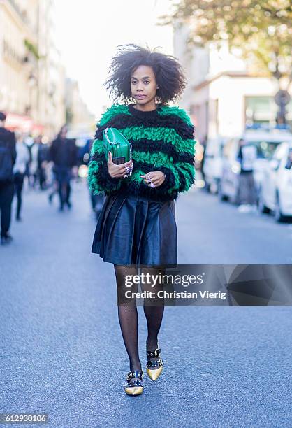 Jan-Michael Quammie wearing a sweater and leather skirt outside Moncler Gamme Rouge on October 5, 2016 in Paris, France.