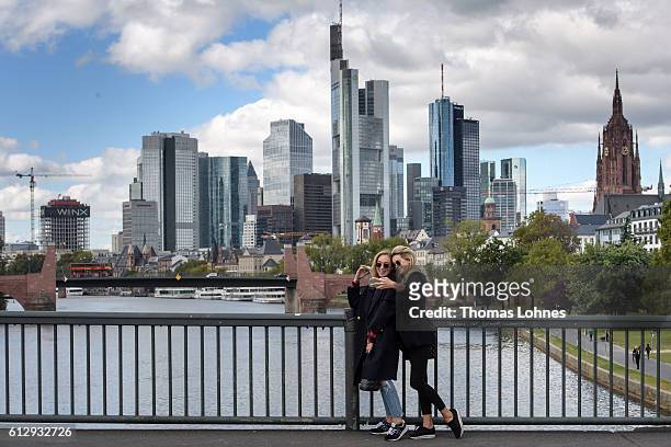 To young women take a selfie photo with the skyline of Frankfurt on October 5, 2016 in Frankfurt, Germany. Banks across Europe are struggling as...