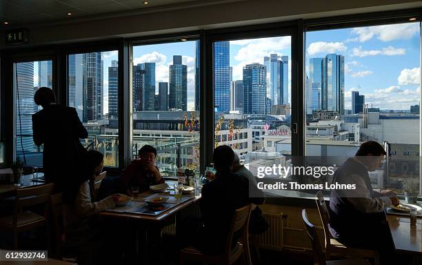 People eat in a restaurant with the view to the finance district of Frankfurt on October 5, 2016 in Frankfurt, Germany. Banks across Europe are...