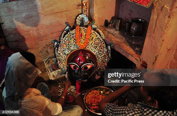 Hindu devotee perform prayer to a mask of Hindu Goddess Kali before the traditional 'Kali Swang' during Dussehra Festival in Daraganj area in...