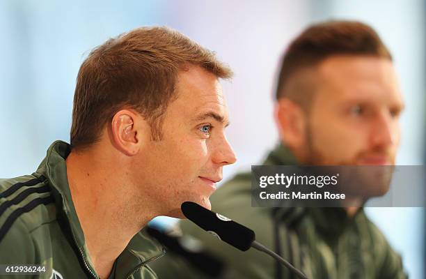 Manuel Neuer and Shkodran Mustafi of Germany talk during a press conference at Mercedes Autohaus on October 6, 2016 in Hamburg, Germany.