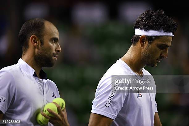 Juan Sebastian Cabal of Colombia and Robert Farah of Colombia leave the court after winning the men's doubles quarterfinals match against Jamie...