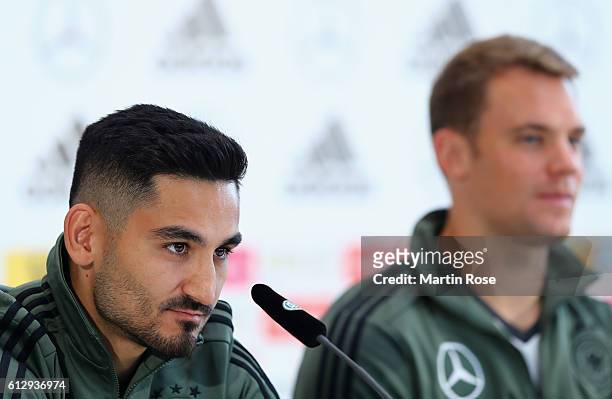 Ilkay Guendogan of Germany talks with Manuel Neuer during a press conference at Mercedes Autohaus on October 6, 2016 in Hamburg, Germany.