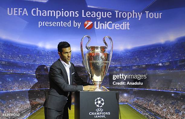 Spanish footballer Luis Garcia poses with UEFA Champions League trophy as it displayed in Vijecnica Library in Sarajevo, Bosnia and Herzegovina on...