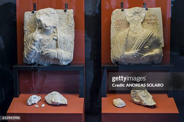 Picture shows two busts whose faces were hammered away by Isis members at Palmyra's Museum in Syria, as part of an exhibition called "Rising from...