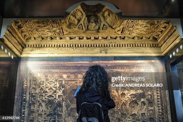 Visitor looks at a reconstitution of the ceiling of the cella of Bel's Temple of Palmyra, as part of an exhibition called "Rising from Destruction...