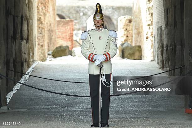 Corazziere stands in front of the entrance of the exhibition, "Rising from Destruction Ebla, Nimrod, Palmyra", at ancient Colosseum in central Rome,...