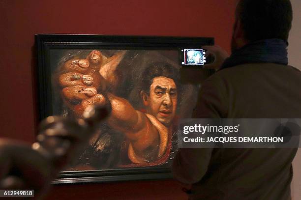 Visitor takes a picture of the painting "Self Portrait " by Mexican painter David Alfaro Siqueiros during the exhibition "Mexique : Diego Rivera,...