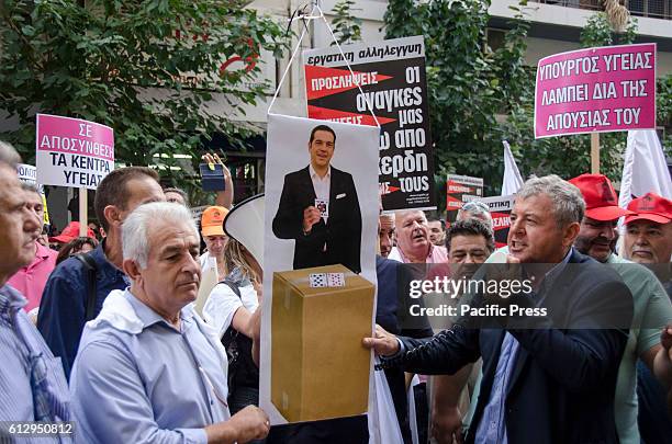 Demonstrators hold pickets with the image of Greek Prime Minister Alexis Tsipras that depict him as a liar. Greek Hospital Employees demonstrate in...