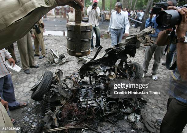 Ahmedabad serial Bomb blasts - Policemen inspect the site where two blasts took place at Civil Hospital. A burnt tiffin box was collected as evidence.