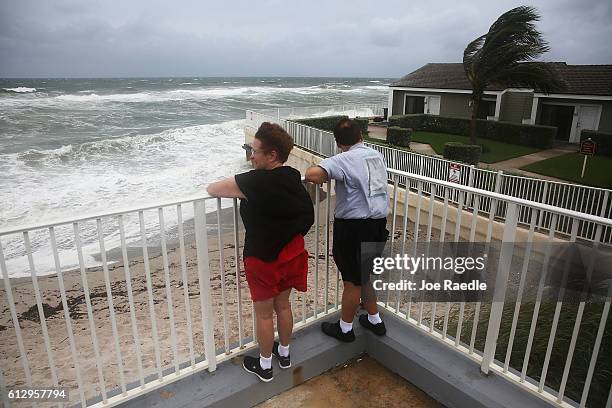 Karen Lanman and Don Lanman look out at the churning ocean as Hurricane Matthew approaches the area on October 6, 2016 in Jupiter, Florida. The...