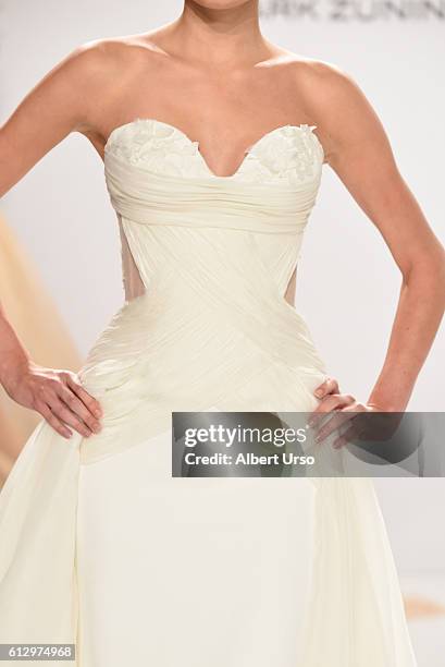 Model, dress detail, walks the runway at the Mark Zunino For Kleinfeld show during New York Fashion Week: Bridal at Kleinfeld on October 6, 2016 in...