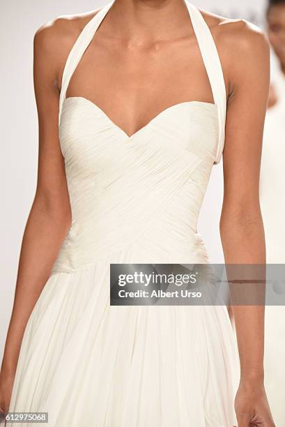 Model, dress detail, walks the runway at the Mark Zunino For Kleinfeld show during New York Fashion Week: Bridal at Kleinfeld on October 6, 2016 in...