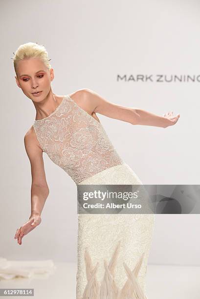 Model falls on the runway at the Mark Zunino For Kleinfeld show during New York Fashion Week: Bridal at Kleinfeld on October 6, 2016 in New York City.